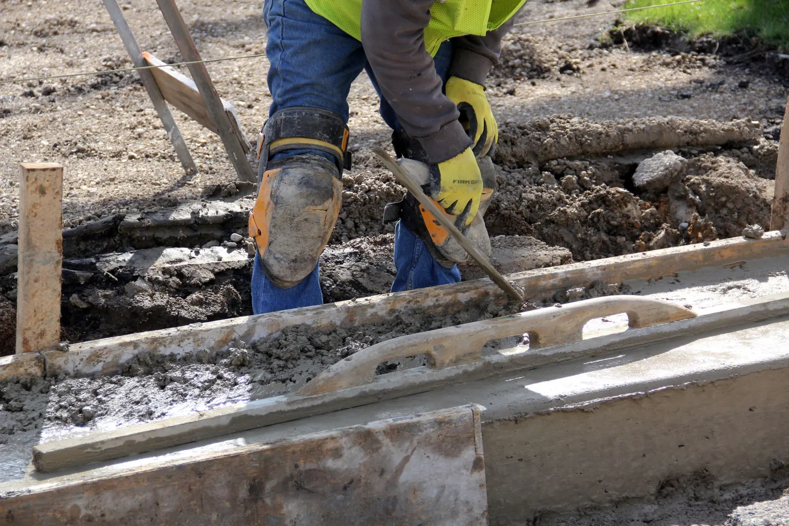 Concrete worker finishing the edge of an exterior concrete placement.